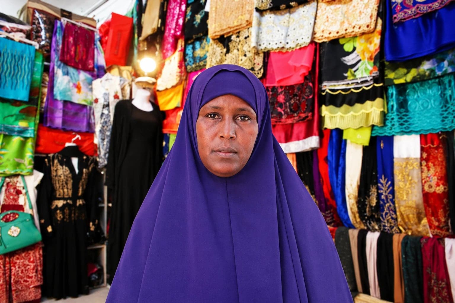 A woman trader in her fabric and clothing shop